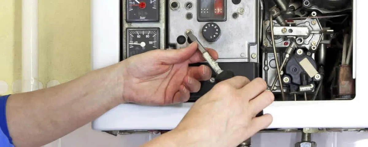 Heating repair technician adjusting boiler controls and components in Orange, CA